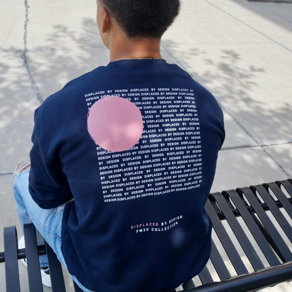Back view of adult in streetwear sitting on bench, stylish graphic design.